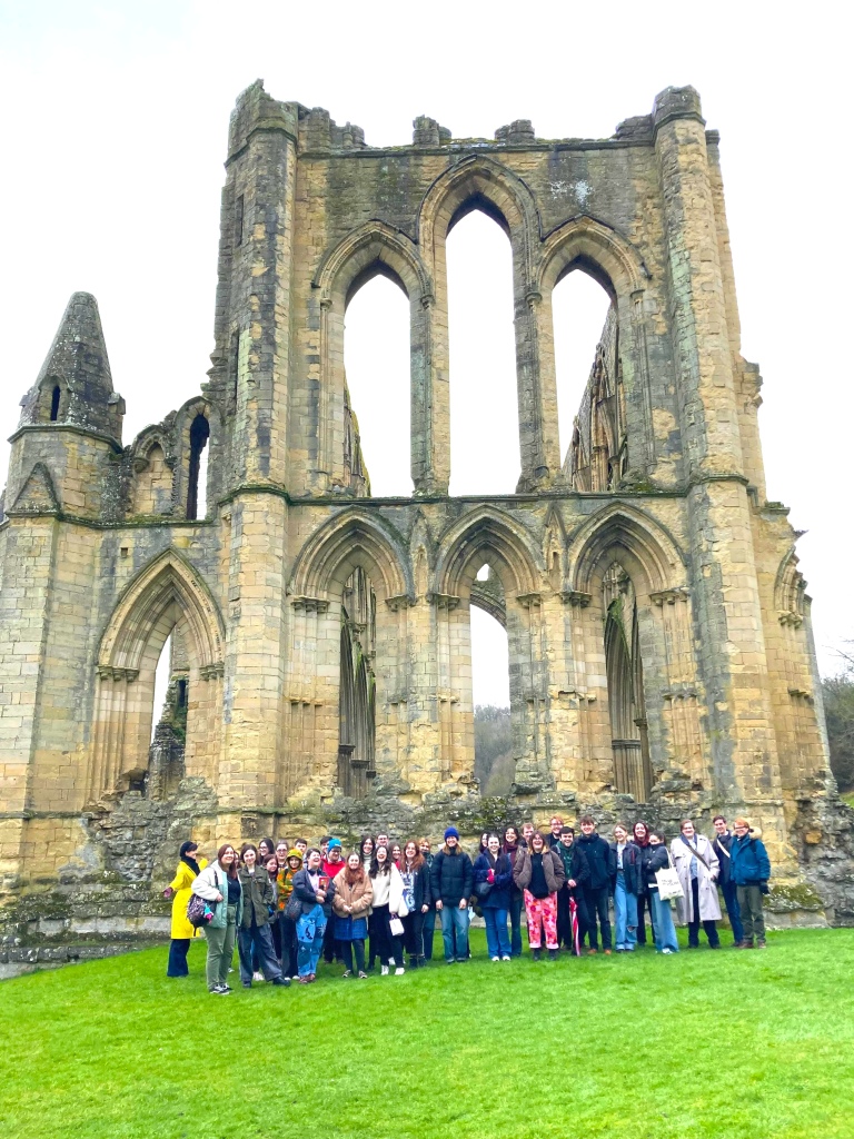 Image of group of students in front of Rievaulx Abbey